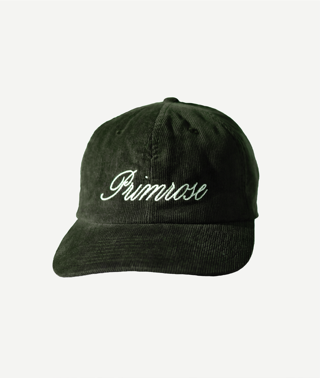 Green corduroy cap with a logo on a white background