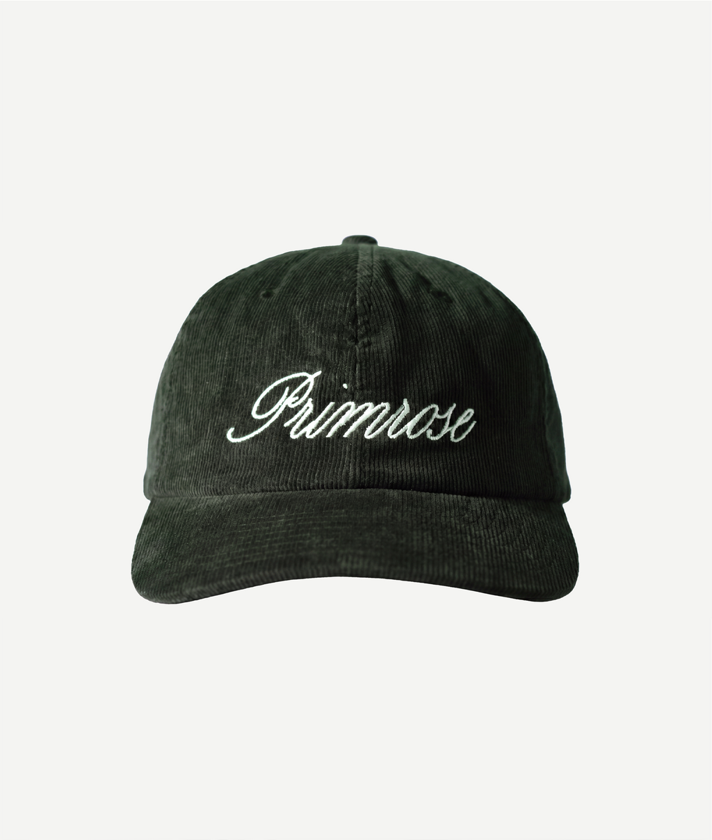 Green cap with 'Primrose' embroidery on a white background