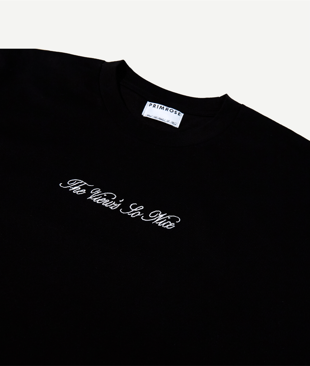 Black t-shirt with white text on a white background