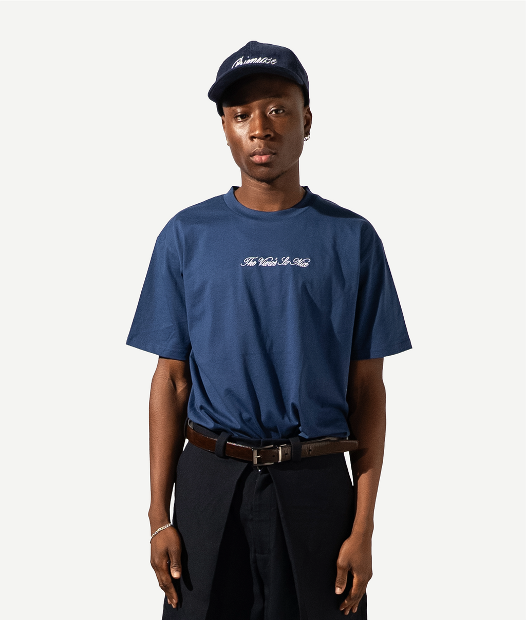 Person wearing a blue t-shirt and cap on a white background