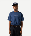 Person wearing a blue t-shirt and cap on a white background