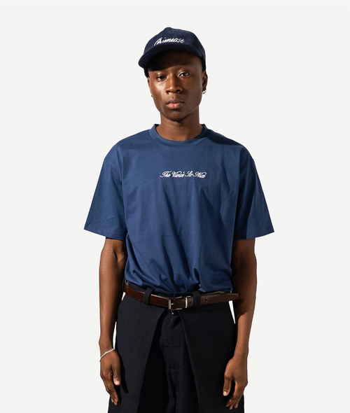 Person wearing a blue t-shirt and cap on a white background